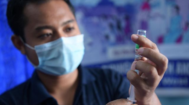 A health worker prepares a dose of the Covid-19 vaccine in Agartala. (Express Photo: Abhisek Saha, File)