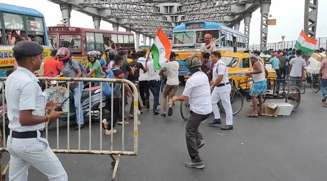 Police try to disperse protesters on the Howrah Bridge in Kolkata on Friday. (Express Photo/File)