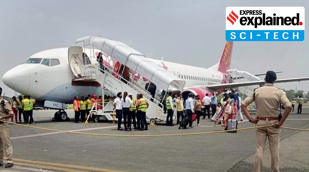 Passengers come out of the Delhi-bound SpiceJet airplane following its emergency landing after it caught fire mid-air, at Jai Prakash Narayan airport, in Patna, Sunday. (PTI)