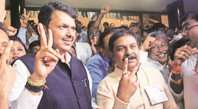 Opposition leader Devendra Fadnavis celebrates after BJP's victory, at the Vidhan Bhavan on Monday.  (Express Photo by Ganesh Shirsekar)