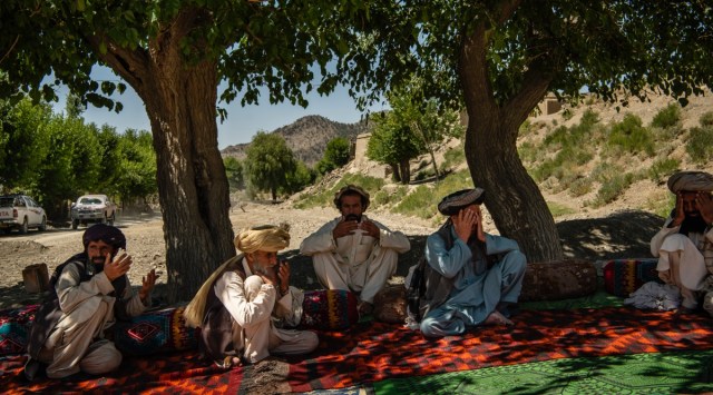 A group of men pray in the village of Azor Kolai, Afghanistan, June 24, 2022. (Kiana Hayeri/The New York Times)