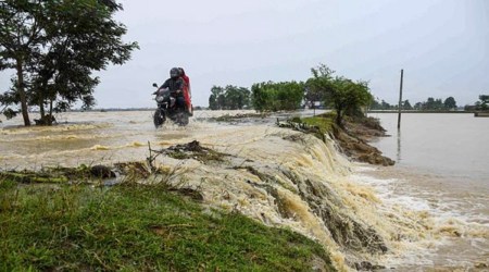 People ride a bike on a waterlogged road after heavy rainfall, at a village in Nagaon district, Friday, June 17, 2022. (PTI)
