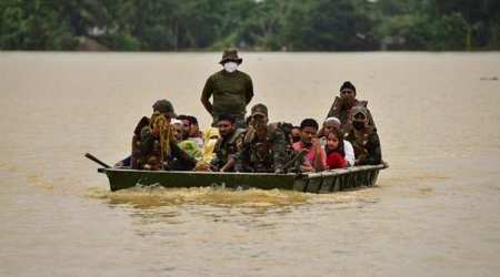 Indian Army soldiers evacuate people from flooded area to a safer place after heavy rains at a village in Hojai district, in Assam. (Reuters)