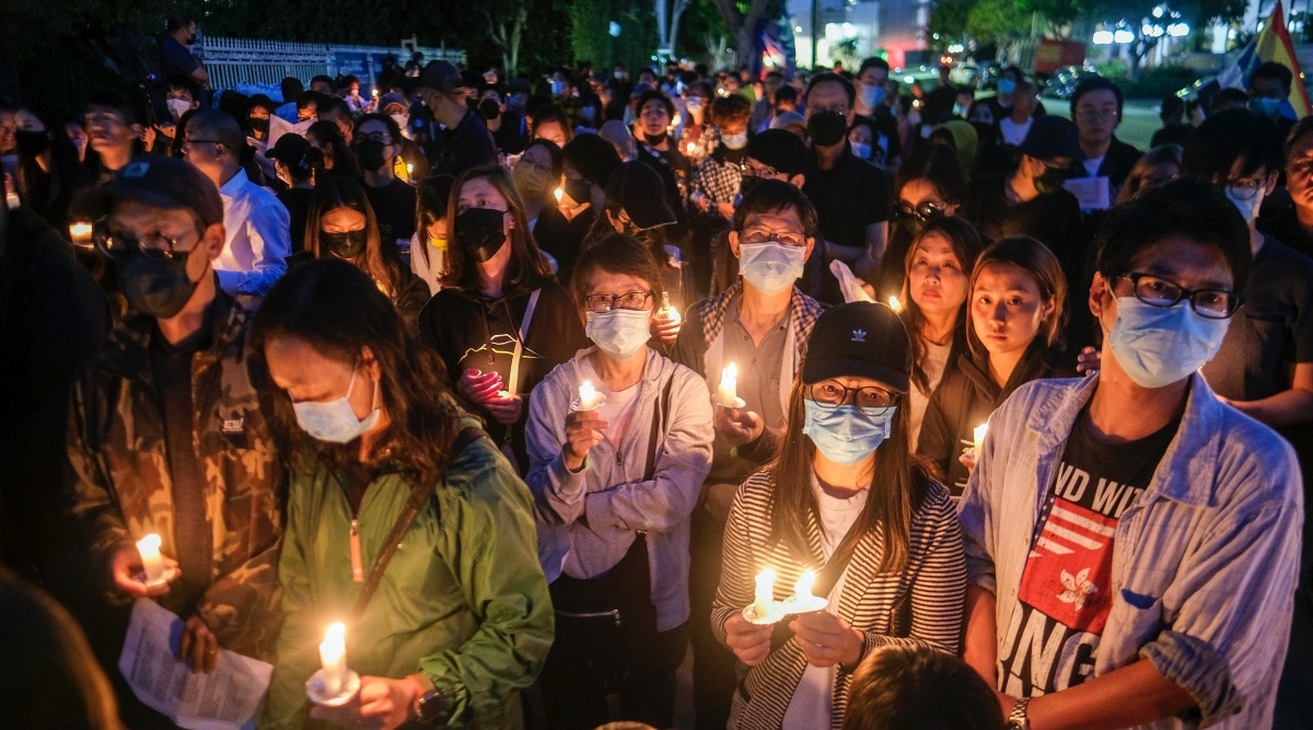People attend a candlelight vigil outside the Chinese Consulate General in Los Angeles on Saturday, June 4, 2022, to mark the 33rd anniversary of the crackdown on the pro-democracy protests in Beijing's Tiananmen Square. (AP Photo)
