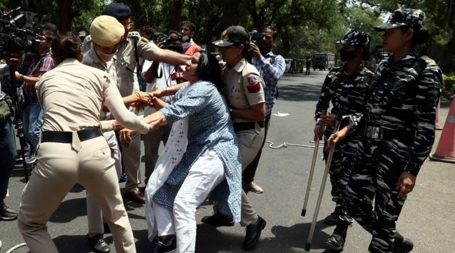 Police personnel detain Congress functionaries protesting against the questioning of Rahul Gandhi by the ED. (Express Photo: Prem Nath Pandey)