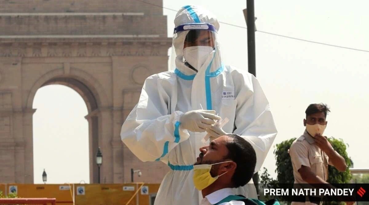 A health worker collects swab sample from a person for Covid-19 test. (Express file photo)