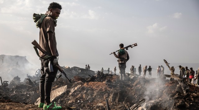 Tigray Defense Force fighters survey the wreckage of an Ethiopian Air Force plane downed in Mekelle, Ethiopia, June 23, 2021. (Finbarr O'Reilly/The New York Times)