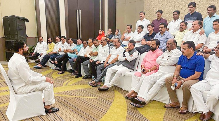 Rebel Shiv Sena leader Eknath Shinde interacts with supporting MLAs at a hotel in Guwahati on Thursday. (Photo: PTI)