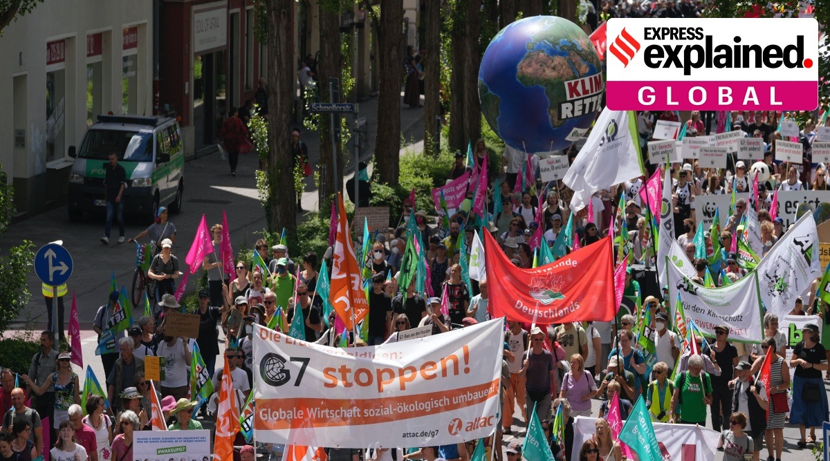 Climate activists and others hold banners and signs as they march during a demonstration ahead of a G-7 meeting in Munich, Germany, June 25, 2022. (AP Photo)