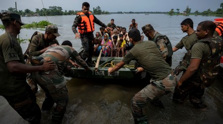 Indian army personnel rescue flood-affected villagers at Tarabari village, west of Guwahati, on Monday. (Photo: AP)