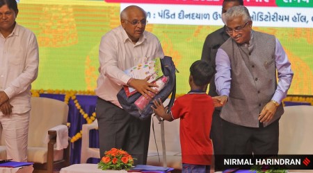 Gujarat CM Bhupendra Patel and Chief Justice of Gujarat HC Aravind Kumar distribute school bag kit to students during 'Shala Praveshotsav' held for new students of state govt's 'Signal Schools' program at Bodakdev. (Express photo by Nirmal Harindran)