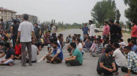 Members of the Kashmiri Pandit community protest on the Srinagar-Jammu national highway, on Tuesday. (Express photo)