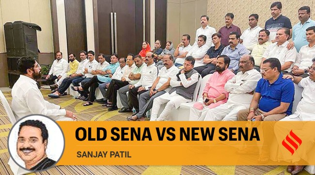 Rebel Shiv Sena leader Eknath Shinde interacts with MLAs supporting him at a hotel in Guwahati. (Photo: PTI)