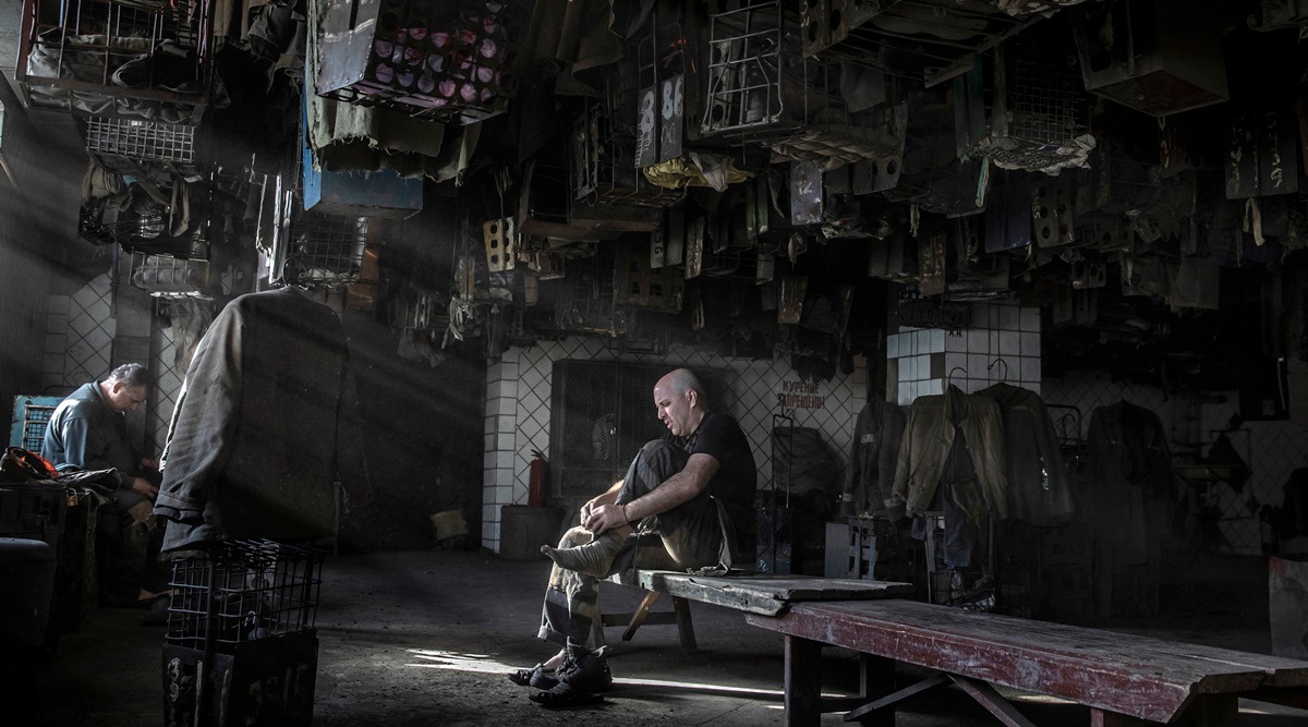 A miner gears up in a communal changing room before a shift at a state-run coal mine near the town of Selidove, in eastern Ukraine’s Donbas region, June 8, 2022. Russia’s heavy, indiscriminate bombing has added yet another threat to Ukraine’s aging coal mines, where personal fears and global anxieties meet. (Finbarr O'Reilly/The New York Times)