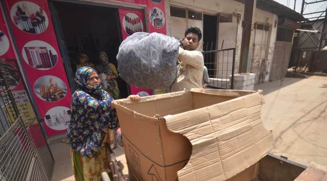 A shopkeeper shifts his belongings in Prayagraj. (Express Photo)