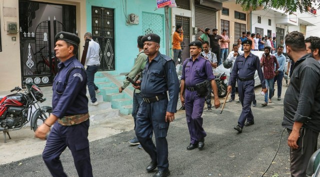 Police personnel patrol a street during restrictions imposed after the murder of tailor Kanhaiya Lal, in Udaipur, Wednesday. (PTI)
