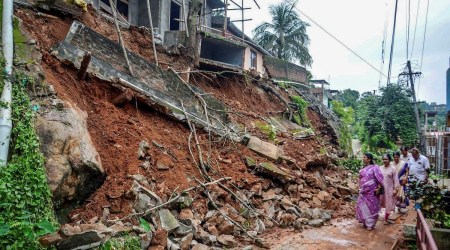 The boundary wall of Guwahati Municipal Corporation's office collapsed after heavy rainfall, at Chandangiri in Guwahati, Sunday. (PTI)