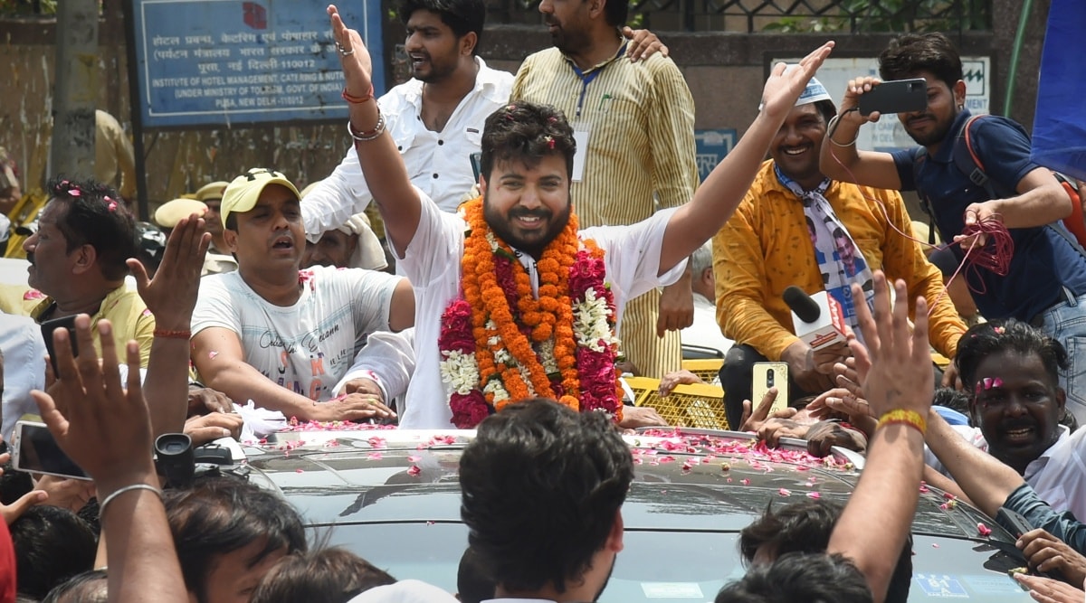 AAP candidate Durgesh Pathak celebrates with supporters after winning Rajinder Nagar by-elections, in New Delhi, Sunday, June 26, 2022. (PTI Photo)