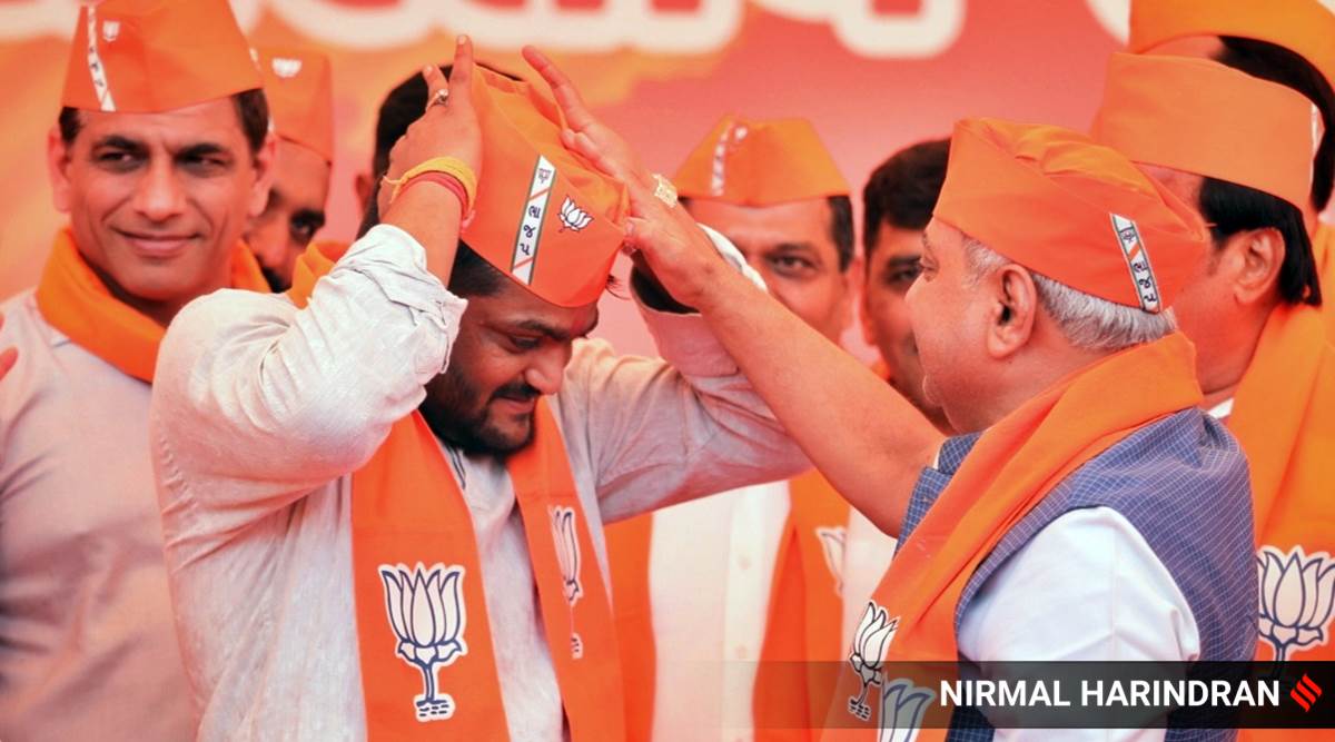 Patidar leader Hardik Patel joins BJP at 'Kamalam', the BJP headquarters in Gandhinagar, in the presence of state president C R Paatil and former Dy CM Nitin Patel on Thursday. Express Photo by Nirmal Harindran