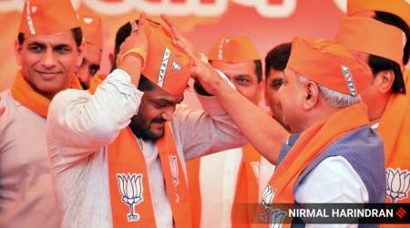 Patidar leader Hardik Patel joins BJP at 'Kamalam', the BJP headquarters in Gandhinagar, in the presence of state president C R Paatil and former Dy CM Nitin Patel on Thursday. Express Photo by Nirmal Harindran