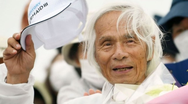 Japanese Kenichi Horie gets celebrated at a yacht harbor in Nishinomiya, western Japan, Sunday, June 5, 2022, after he completed his solo nonstop voyage across the Pacific Saturday. (Kosuke Moriwaki/Kyodo News via AP)