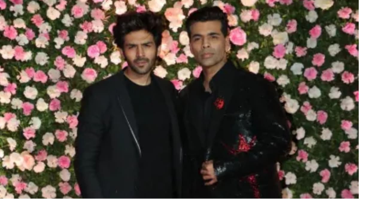Kartik Aaryan and Karan Johar at Kapil Sharma's Mumbai wedding reception. (Express Photo: Varinder Chawla)