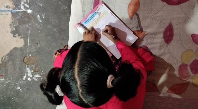 Keerti at home. Her father, a fruit seller, says there’s no one at home who can help his children with studies. (Express photo by Sukrita Baruah)