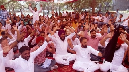 Liquor contractors from Punjab protest against the new liquor policy outside the Excise and Taxation Department, Mohali, on Tuesday. (Express Photo)