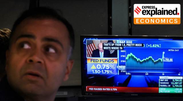 A screen displays the Fed rate announcement as a trader works (inside a post) on the floor of the New York Stock Exchange (NYSE) in New York City. Reuters