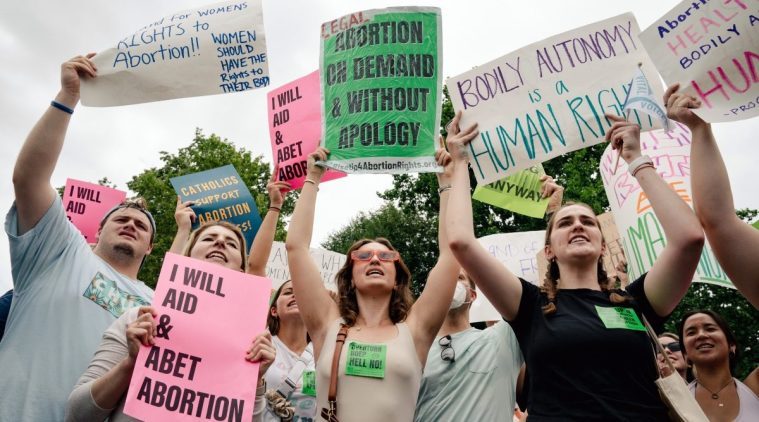 Abortion rights activists gather to protest outside the Supreme Court in Washington. (The New York Times)