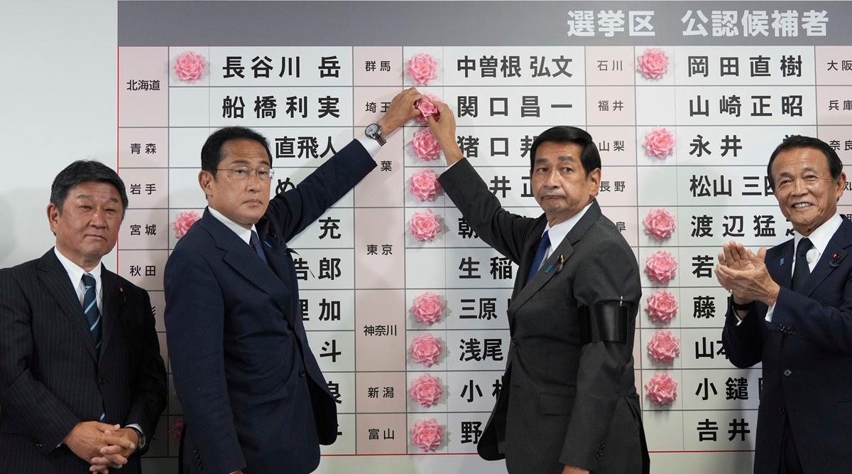 Fumio Kishida, second left, Japan's prime minister and president of the Liberal Democratic Party (LDP), speaks after placing a red paper rose on an LDP candidate's name, to indicate a victory in the upper house election, at the party's headquarters in Tokyo, Japan, on Sunday, July 10, 2022. (AP)