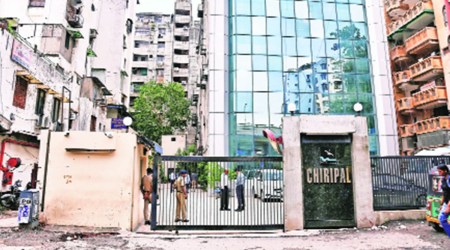 Police personnel outside the office of Chiripal group in Ahmedabad during the IT raids on Wednesday. (Express photo)