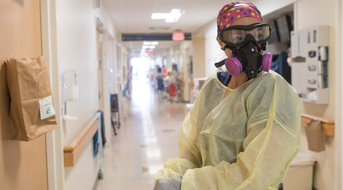 A health care worker wears an elastomeric respirators at Yale New Haven Hospital in New Haven, Conn., April 30, 2020. Experts say the U.S. government has unintentionally encouraged a dependency on imported masks by failing to promote elastomeric respirators, a reusable mask that is domestically produced. (Image credit: Kirsten Luce/The New York Times)