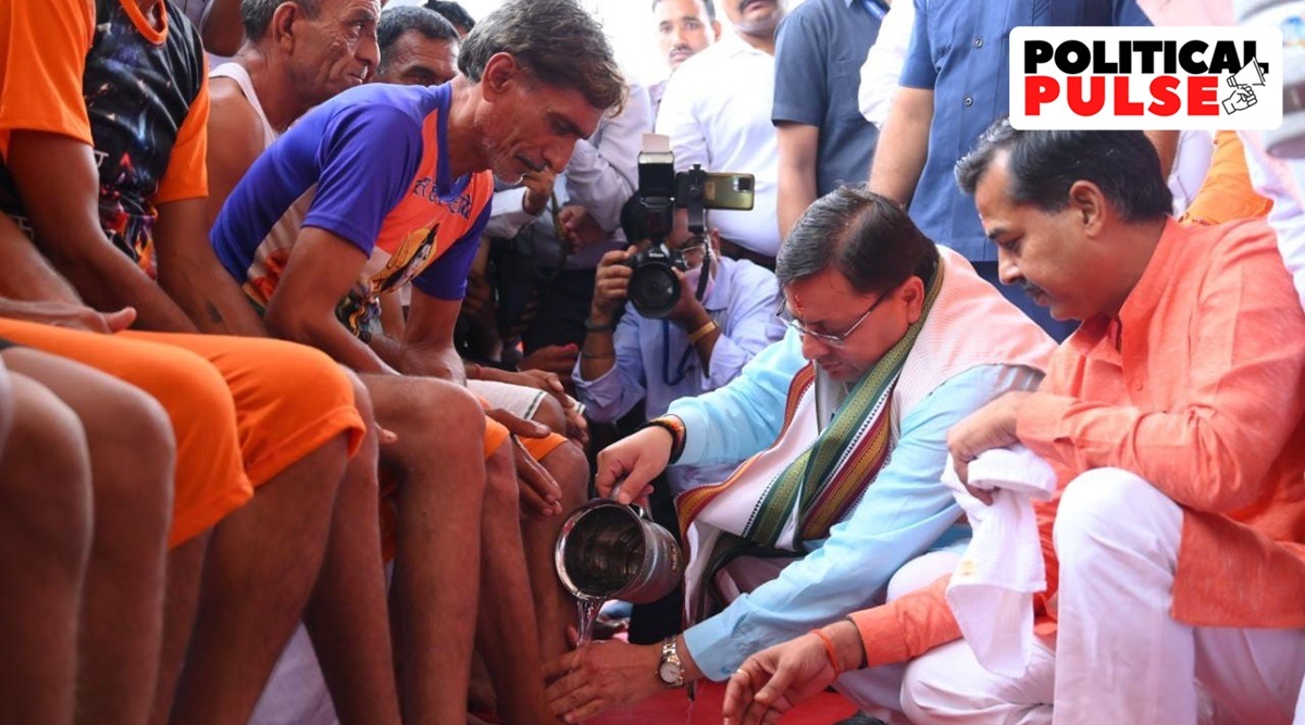 Uttarakhand Chief Minister Pushkar Singh Dhami washing pilgrims' feet. (Express photo)