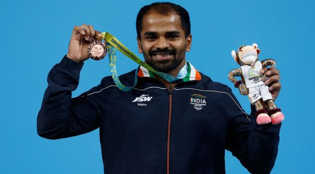 Bronze medallist India's Gururaja Poojary celebrates on the podium. (Reuters)