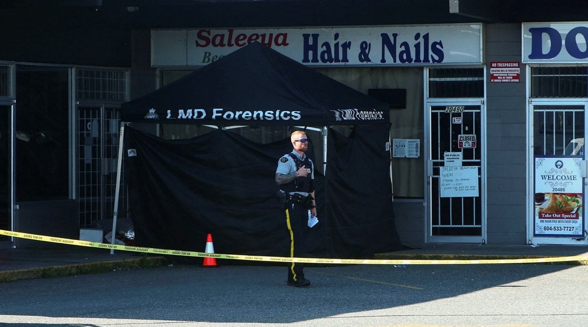 A police officer stands near a crime scene after authorities alerted residents of multiple shootings targeting transient victims in the Vancouver suburb of Langley, British Columbia, Canada, July 25, 2022. (REUTERS)
