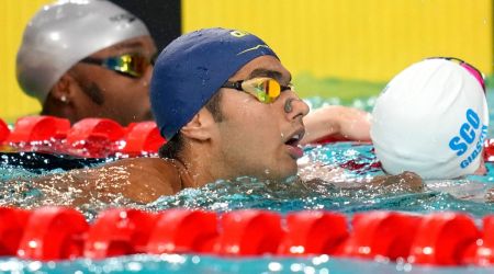Srihari Natraj of India, centre, reacts after competing in the Men's 50m Backstroke heat during the swimming at the Commonwealth Games. (Reuters)