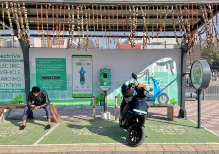 A man waits as his electric scooter gets charged at an electric charge station in New Delhi (Representational Reuters file photo) 