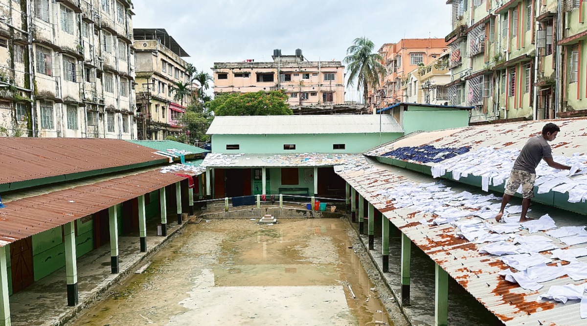  At the Durga Shankar Pathshala, a lower primary school in Silchar, a caretaker lays out school uniforms to dry on the roof. (Express photo by Tora Agarwala)