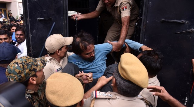An accused in Udaipur killing case being taken back to custody after he was produced at an NIA court, in Jaipur. (Express photo by Rohit Jain Paras)