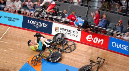 General view of a crash in the Men's 15km Scratch Race Qualifying Round as England's Matt Walls, top left, and Canada's Derek Gee, right, go over the barrier into the crowd at Lee Valley VeloPark on day three of the 2022 Commonwealth Games in London, Sunday July 31, 2022. ( AP)