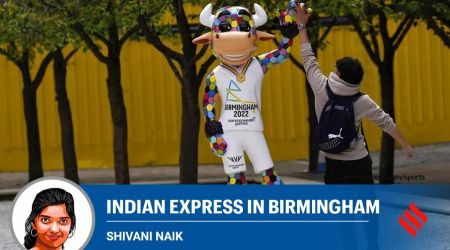 A boy jumps to give a high five to the Commonwealth Games mascot, Perry the Bull, in Birmingham. (AP Photo)