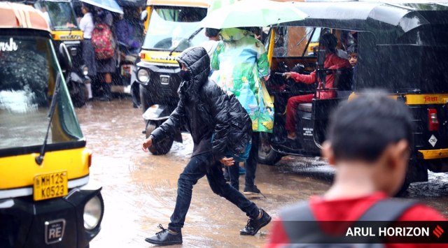 Pune school students heading back home during heavy rains on Wednesday. (Express photograph by Arul Horizon)