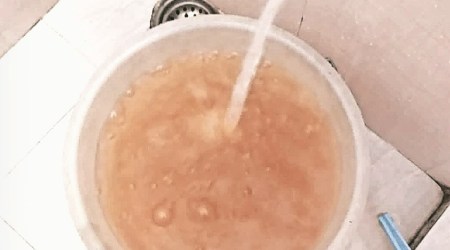 Muddy water runs from a tap in a Panchkula house. (Express Photo)