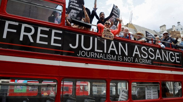 Protesters ride on a bus during a 'Free Assange' demonstration to mark Julian Assange's birthday, in London (REUTERS/John Sibley)