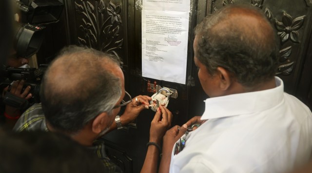AIADMK party head quarters seal being removed by officials of the Revenue Department, in Chennai, Thursday, July 21, 2022. (PTI Photo)