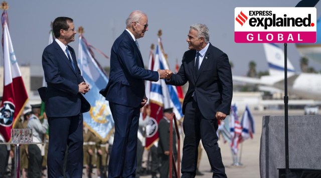 Israeli President Isaac Herzog, left, looks on as President Joe Biden gives a fist bump to Israeli Prime Minister Yair Lapid during an arrival ceremony after arriving at Ben Gurion Airport, Wednesday, July 13, 2022, in Tel Aviv. (AP Photo/Evan Vucci)