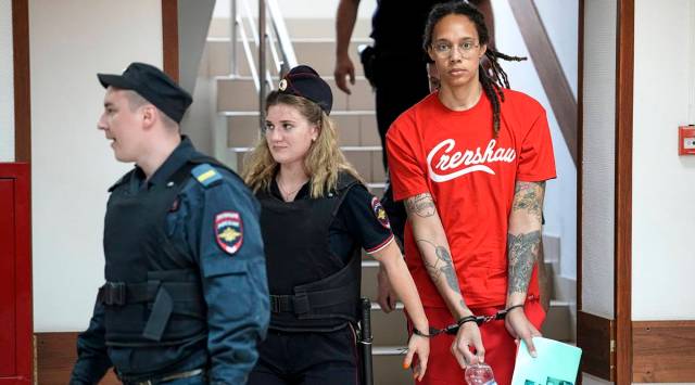 WNBA star and two-time Olympic gold medalist Brittney Griner is escorted to a courtroom for a hearing, in Khimki just outside Moscow, Russia. (AP Photo/Alexander Zemlianichenko)