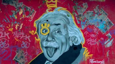 graffiit of einstein on a red painted wall