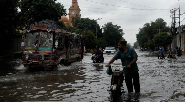 Residents commute through a flooded street, following heavy rains during the monsoon season in Karachi, Pakistan July 25, 2022. (Photo: REUTERS)